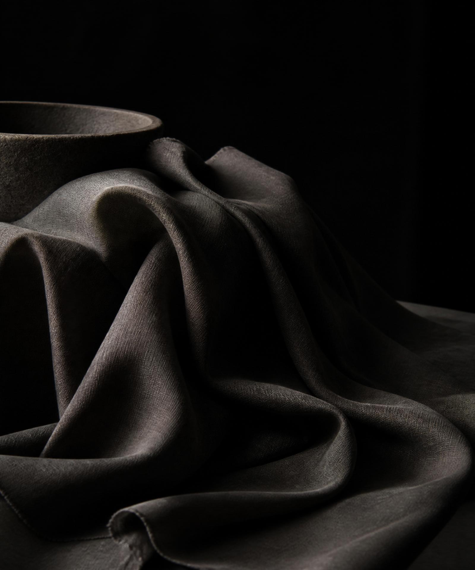 Draped charcoal fabric in low light